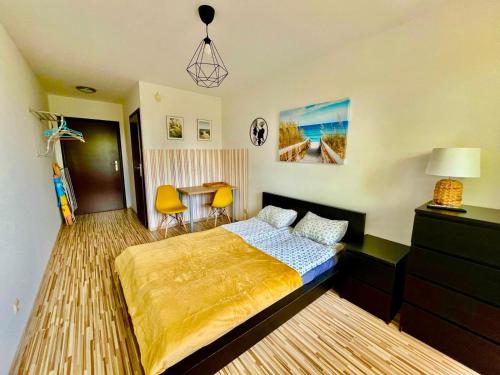 a bedroom with a bed and a table and chairs at Willa Sarbinowo in Sarbinowo