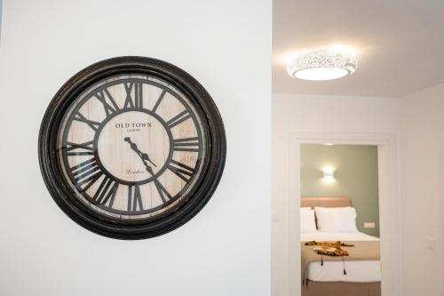 a large clock on a wall in a room at Sophie's Apartments 5 & 6 in Poros