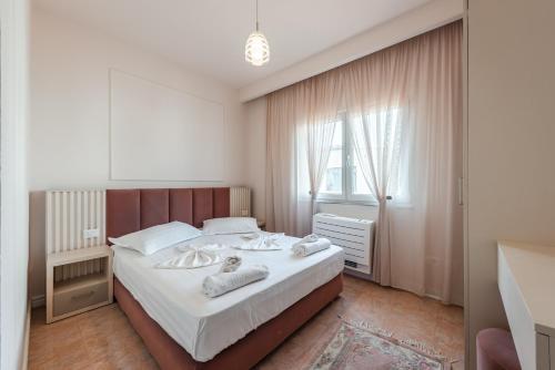 a bedroom with a large bed with white sheets at Sea View Apartments ELDO in Durrës