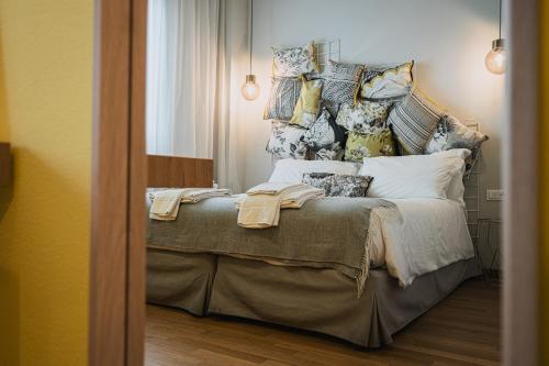 a bedroom with a bed with pillows on it at TORTE & LINI in Bologna