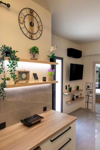 a room with a large clock on the wall at Envy Luxury Suite in Agia Pelagia