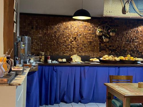 a kitchen with a blue counter with food on it at Vila Alaide Praia Hotel in Barra Velha