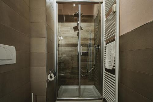 a shower with a glass door in a bathroom at TORTE & LINI in Bologna
