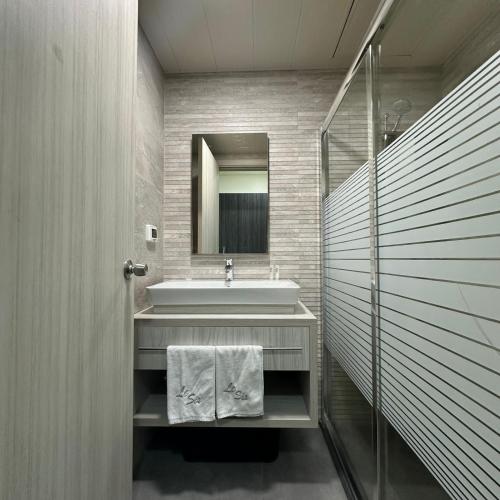 a bathroom with a sink and a mirror at Le Six Hotel And Resort in Batroûn
