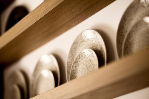 a row of silver shoes on a shelf at Thea Luxury Villas Ios in Plakotos