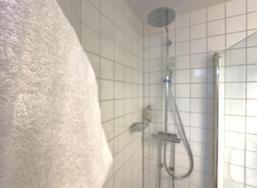 a shower with a shower curtain in a bathroom at Good Morning Örebro in Örebro