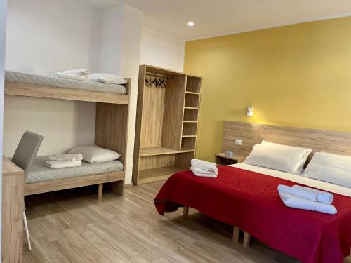 a bedroom with a bed and bunk beds at Salsedine Tropea Capo Vaticano in Santa Domenica