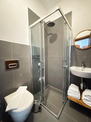 a bathroom with a shower and a toilet and a sink at Casa Alegre Alaçatı in Alacati
