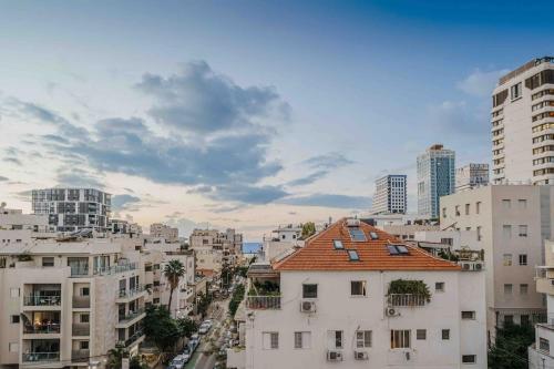 a view of a city with tall buildings at Amazing loft visionary apartment in Tel Aviv