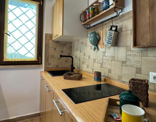 a kitchen with a sink and a counter top at SANS SOUCIS - Design Apartment - Near Nettuno Center, Beach & Station in Nettuno