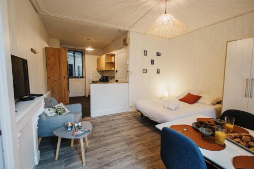 une chambre avec deux lits et un salon dans l'établissement Les Malakoff, à Cherbourg en Cotentin