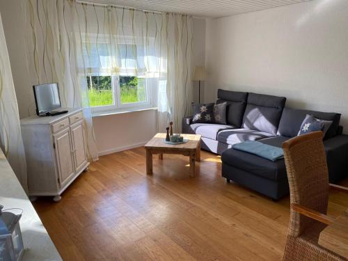 a living room with a couch and a table at Ferienwohnung Am Bürgele in Schopfheim