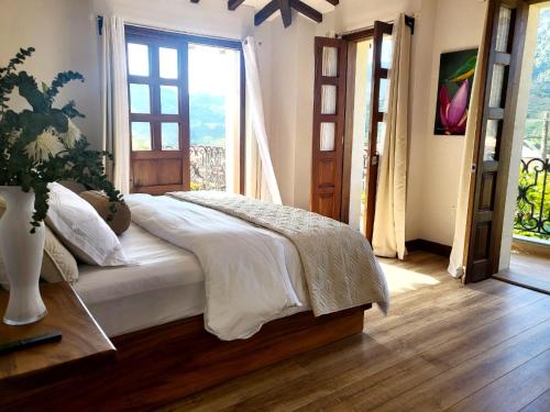 a bedroom with a bed and a large window at WR Boutique Hotel in Jardin