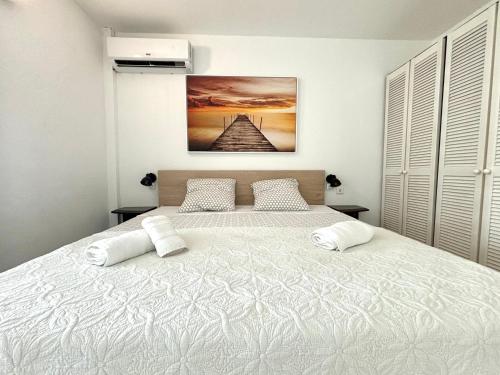 a bedroom with a large white bed with two pillows at La Serena de Toumalacai - Calme et Paisible in Grand-Bourg