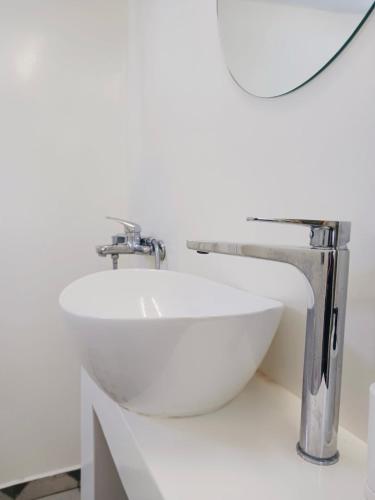 a white sink in a bathroom with a mirror at Amersa's House in Skiros