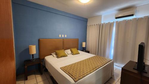 a bedroom with a bed and a television in it at Flat no Condomínio Metrópolis - Ilha do Leite in Recife