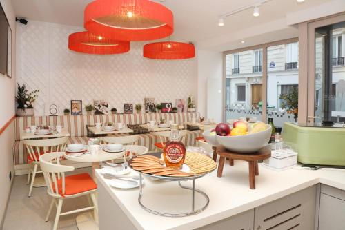 a restaurant with a bowl of fruit on a counter at Five Boutique Hotel Paris Quartier Latin in Paris