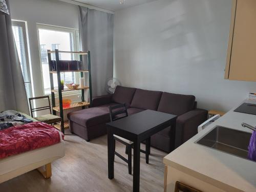 a living room with a couch and a table at Apartment near the Harbour in Turku