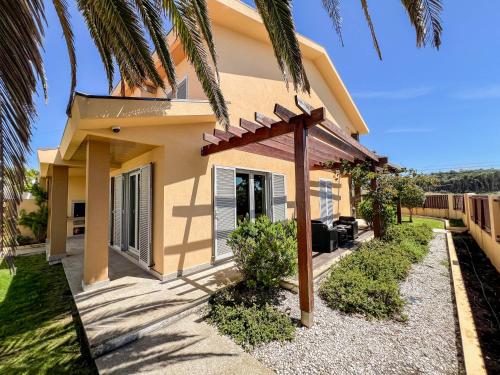 a house with a palm tree in front of it at Casa Atlântico - 5 minutes from the beach in Viana do Castelo
