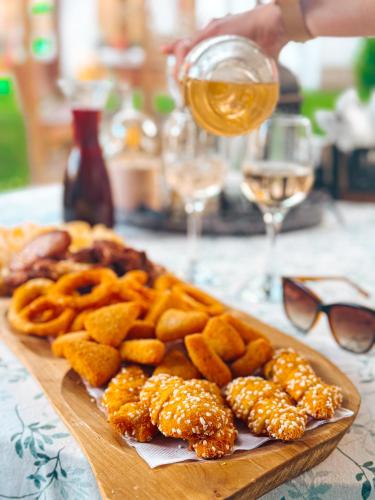 a plate of food on a table with a glass of wine at Jánsky rezort in Liptovský Ján