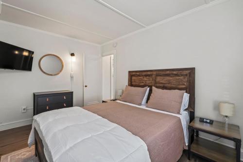 a bedroom with a large bed and a mirror at The Stables by Saratoga Stays in Saratoga Springs