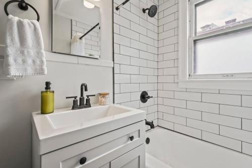a white bathroom with a sink and a shower at The Stables by Saratoga Stays in Saratoga Springs