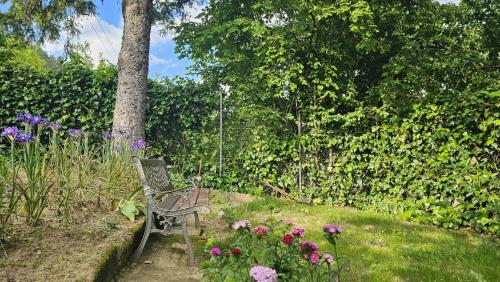 a bench sitting in a garden with flowers at La Veranda in Marradi
