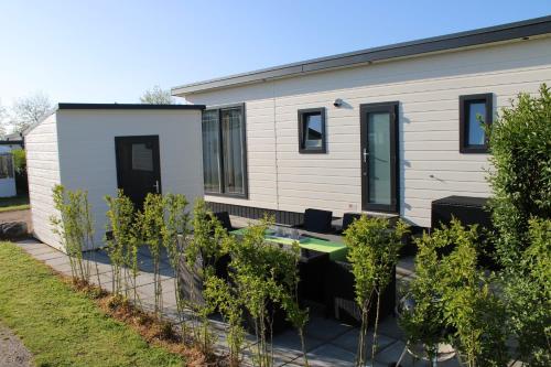 a tiny house with trees in front of it at Chalet Zeeland in Kamperland