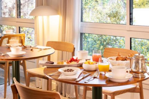 a breakfast table with food and drinks on it at Briqueterie Champagne, A Beauvallon Hotel & Spa in Vinay