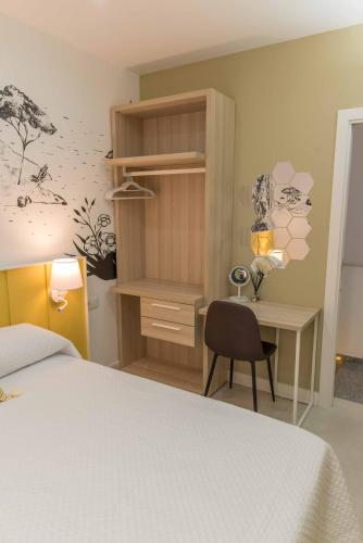 a bedroom with a bed and a desk and a bed and a cabinet at Casa para 8 personas con jardin in Palafolls