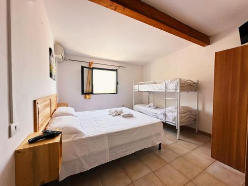 a bedroom with a bed and a bunk bed at Residence Punta Cilento in Pisciotta
