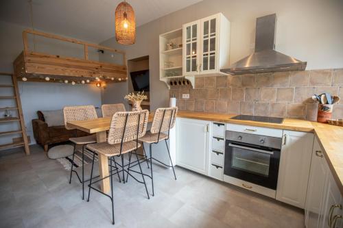 a kitchen with a wooden table and a dining room at Studio La Résilience, au pied des pistes à Autrans in Autrans