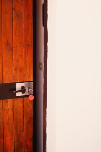 a wooden door with a red tag on it at Residence Punta Cilento in Pisciotta