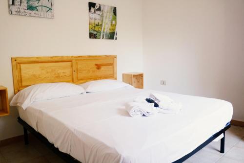 a bedroom with a bed with towels on it at Residence Punta Cilento in Pisciotta