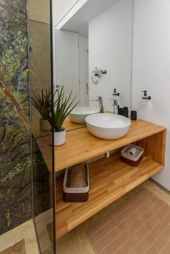 a bathroom with a sink and a mirror at Astria Amalfi - Complex Novum in Olimp