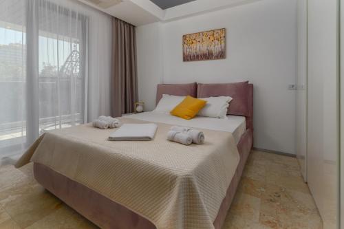 a bedroom with a bed with two stuffed animals on it at Astria Amalfi - Complex Novum in Olimp