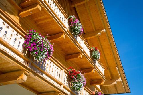 a balcony with potted plants on a building at Rojerhof in Schladming
