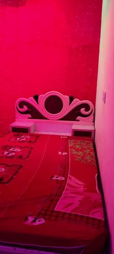 a red room with a toilet in a red room at Shinobi Lakeview Retreat in Nārāyangaon