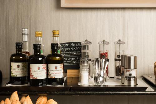 a group of bottles of wine sitting on a counter at Hotel Ciudad de Valladolid in Valladolid
