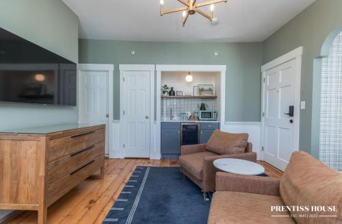 a living room with a couch and a table at Prentiss House by Thatch in Cambridge