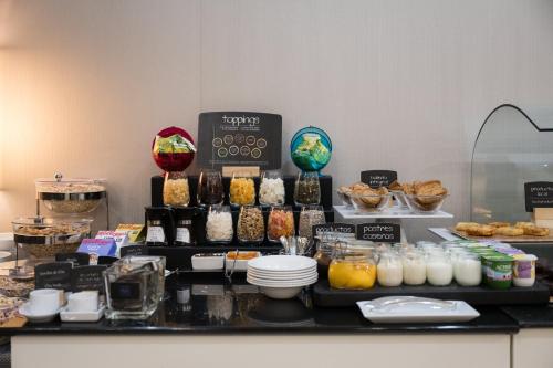 a buffet of food on a counter in a room at Hotel Ciudad de Valladolid in Valladolid