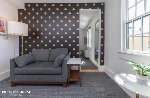 a living room with a couch and a wall with gold stars at Prentiss House by Thatch in Cambridge
