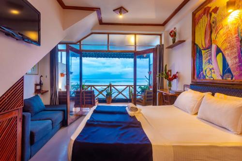 a bedroom with a bed and a view of the ocean at Villa Surf Beach in Galle