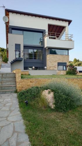 a large white house with a large window at Villa Stadi in Nikiti