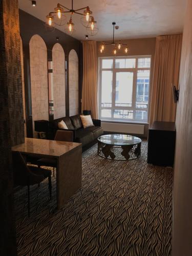a living room with a couch and a table at ArtApart Vozdvigenka in Kyiv