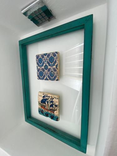 a framed picture of three ties in a refrigerator at Akdeniz Villa in Kas