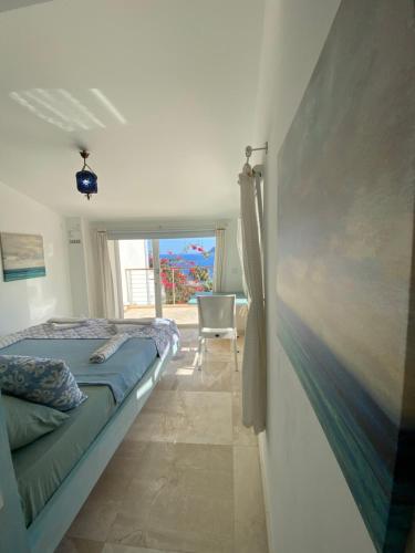a bedroom with a bed and a painting on the wall at Akdeniz Villa in Kas