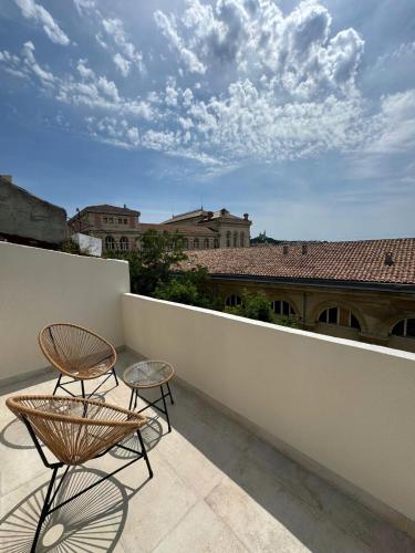 two chairs and a table on a balcony at Maison Senac - Boutique hôtel in Marseille