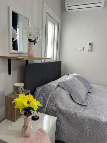 a bedroom with a bed and a table with flowers at New renovated 1 BEDROOM FLAT North NİCOSİA 5A in Yenişehir