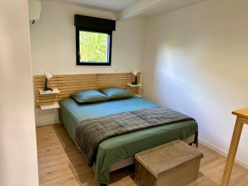 a bedroom with a bed and a window at Maisonette Sainte Victoire in Fuveau